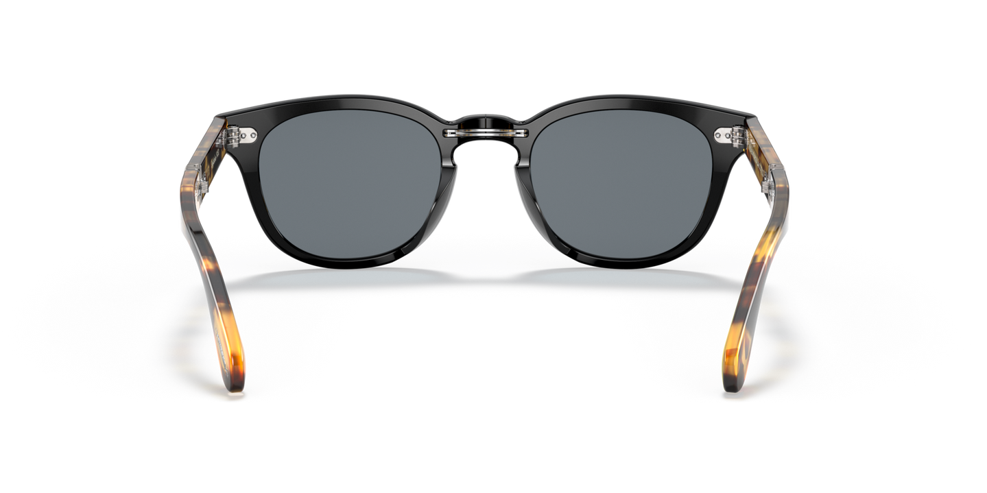 Sie Oliver Peoples Sheldrake 1950 Exclusive mit Black/YTB Gestell und Blau Gläsern - Bild Stegplättchen